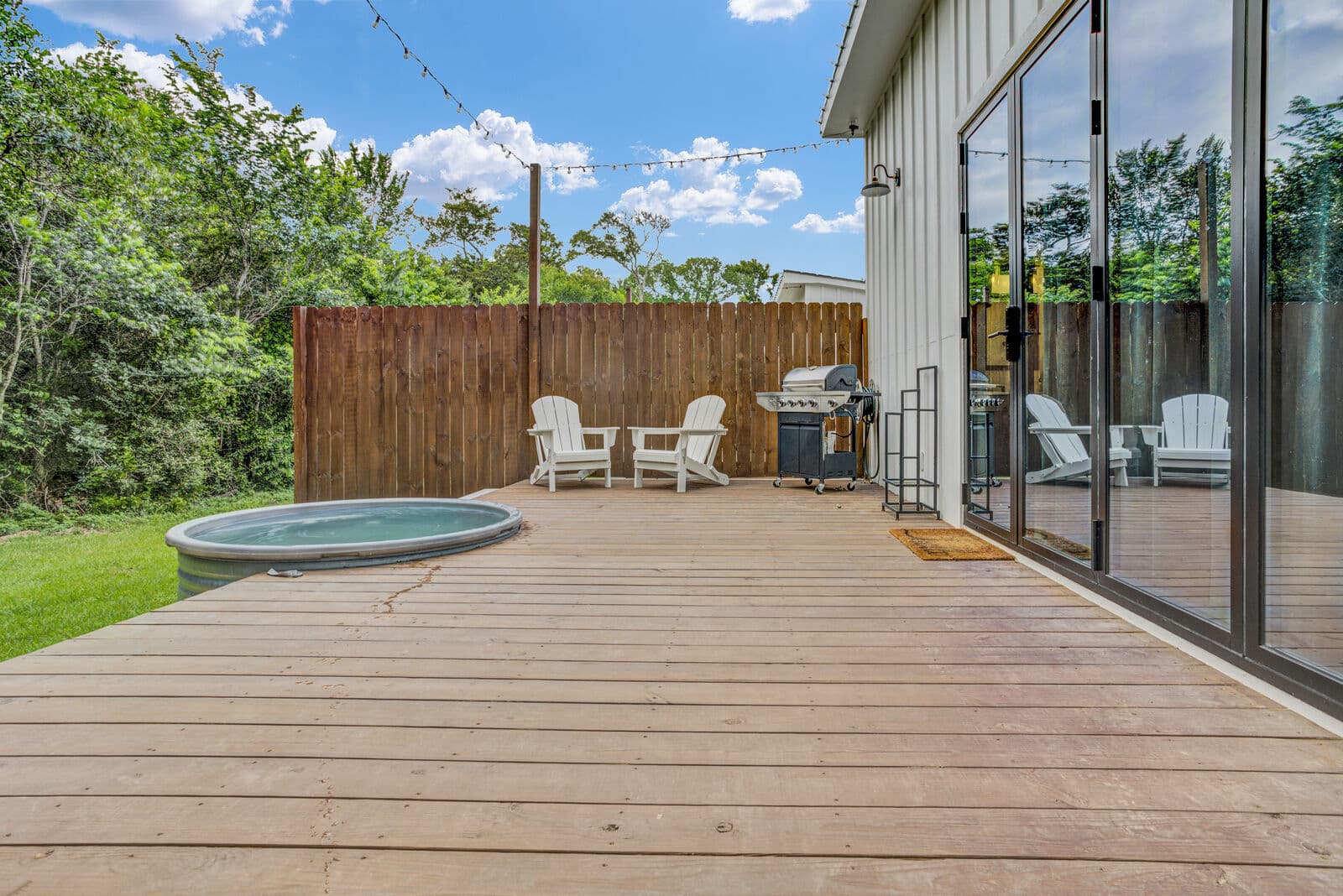 A cowboy hot tub set outdoors under the trees