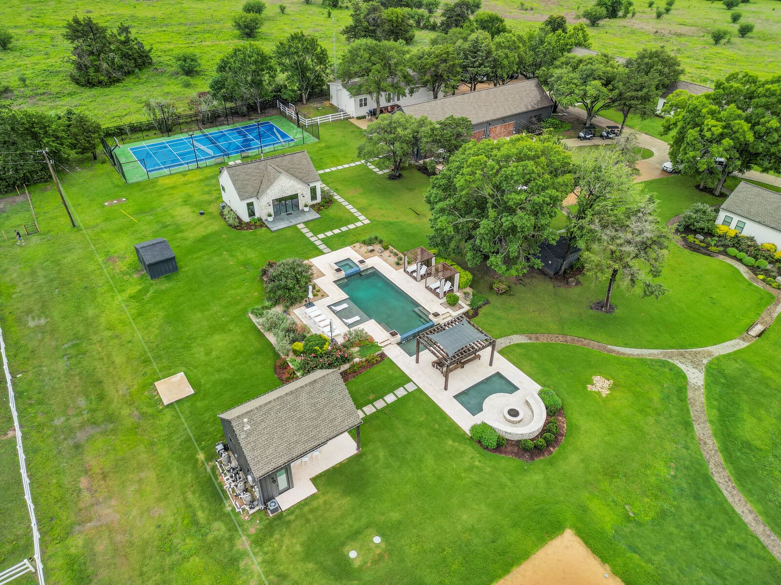 Aerial view of the ranch, showing the lake, pools and pastures across the property